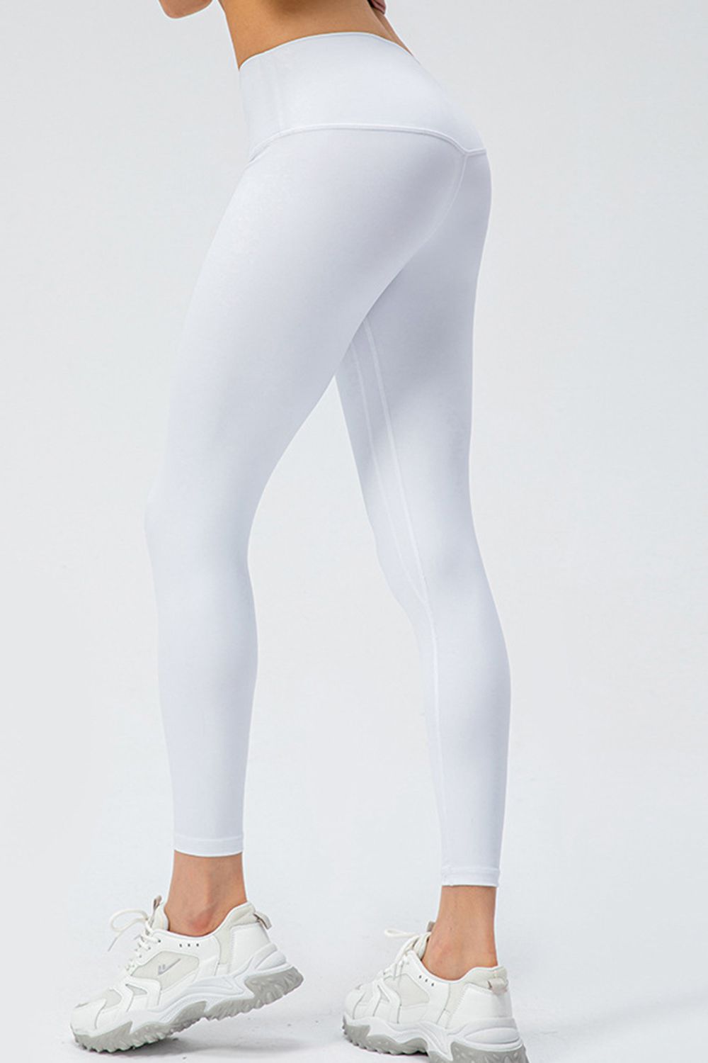Woman wearing white leggings