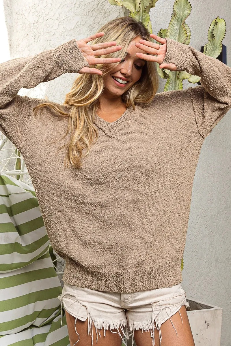 Woman wearing BiBi raw edged popcorn texture V-neck sweater