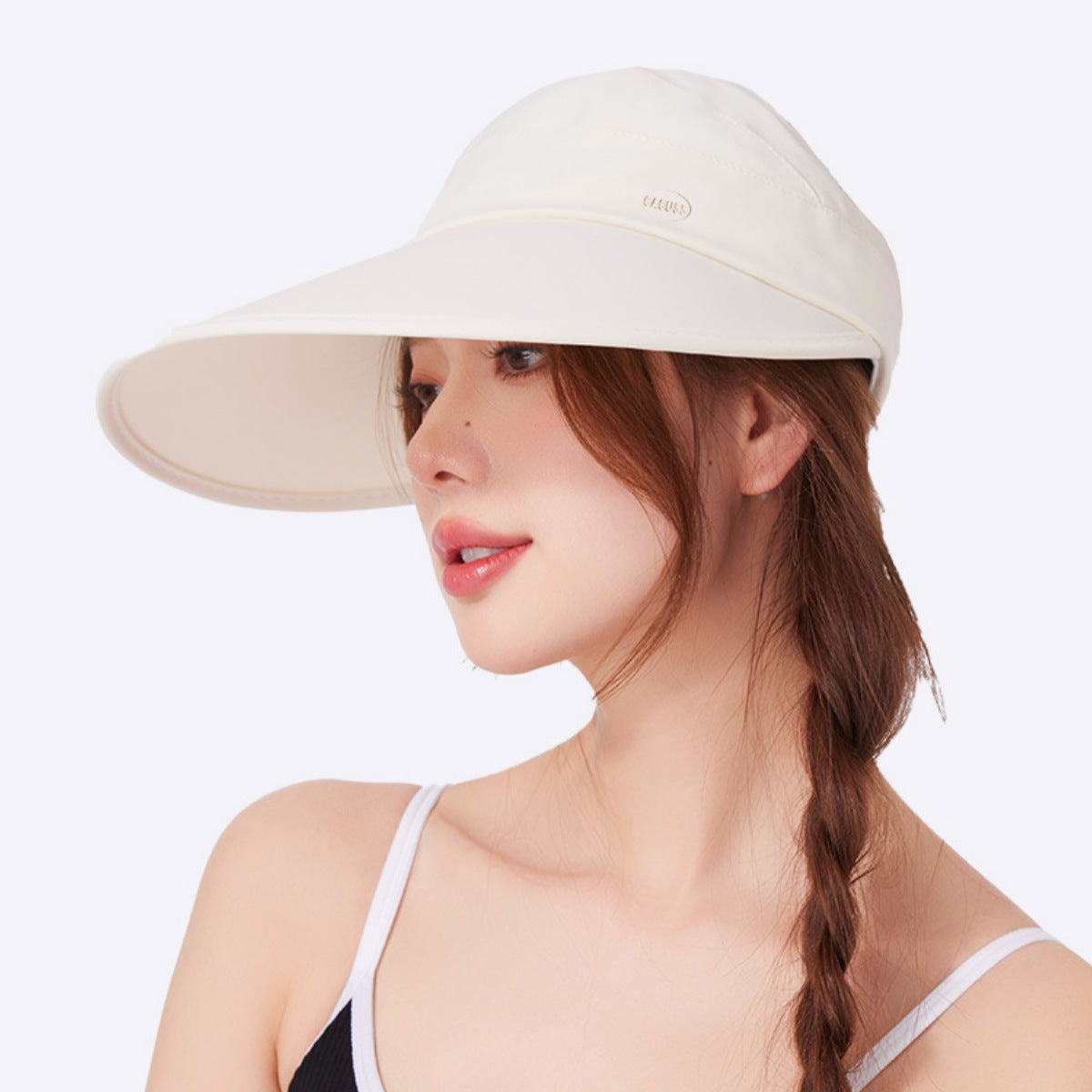 Young lady wearing trendy beige hat