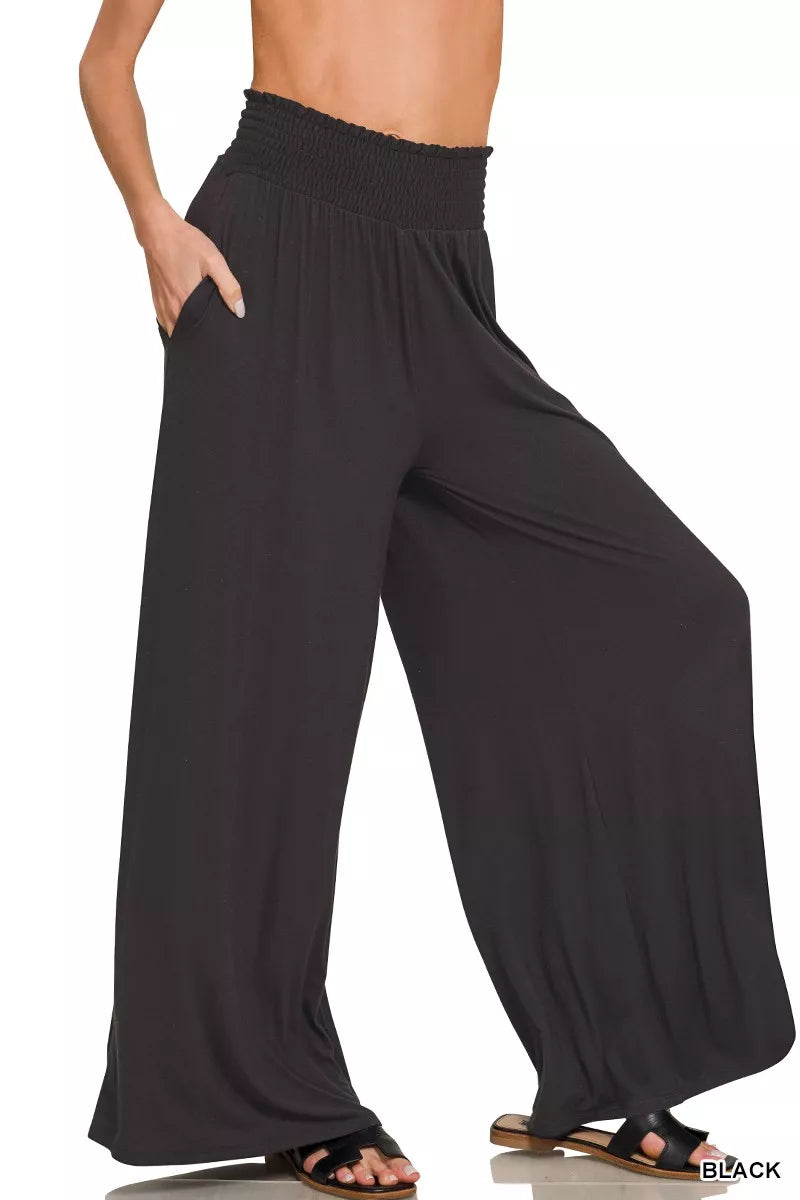 Woman wearing Zenana smocked waist wide leg palazzo pants