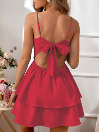 Red dress with open back and bow detail on a neutral background