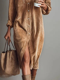 Person wearing a brown corduroy dress holding a matching handbag against a gray background