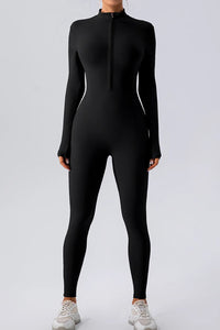 Person wearing a black full-body suit on a white background