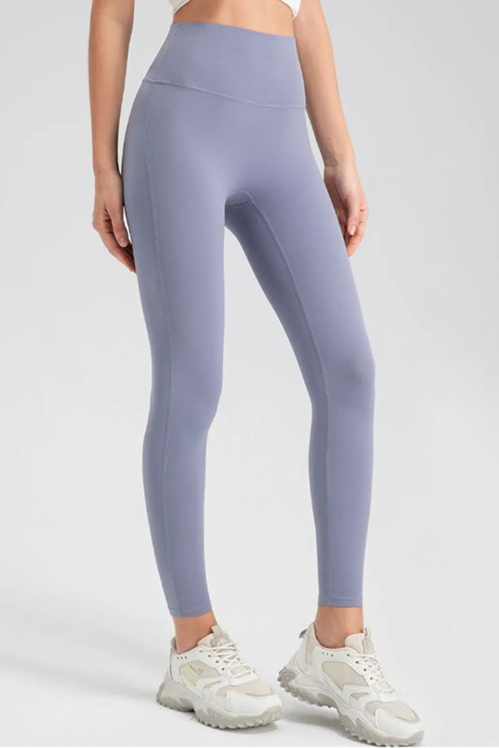 Person wearing light purple leggings on a white background