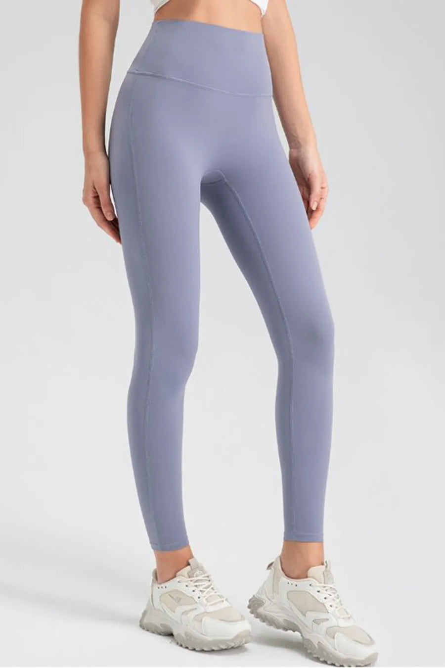 Person wearing light purple leggings on a white background