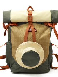 Backpack with roll-top design and circular front pocket on a white background