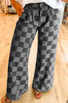 Person wearing checkered pants on a wooden floor