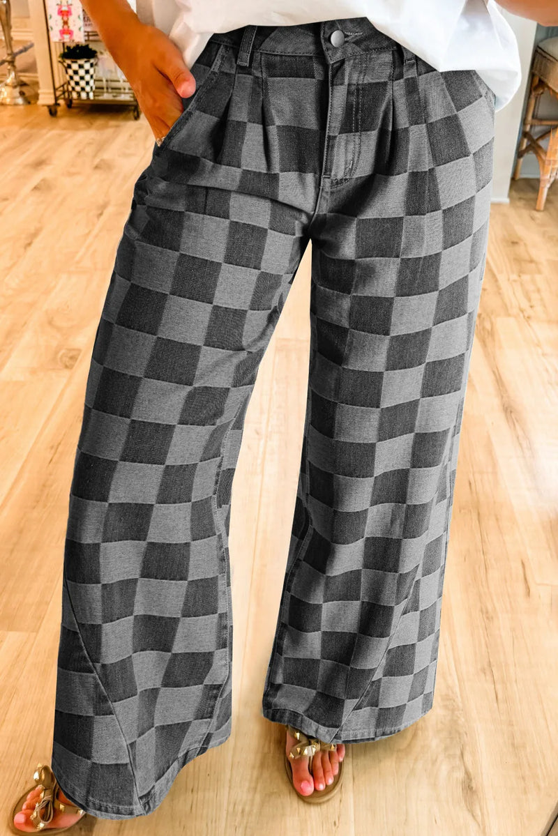 Person wearing checkered pants on a wooden floor