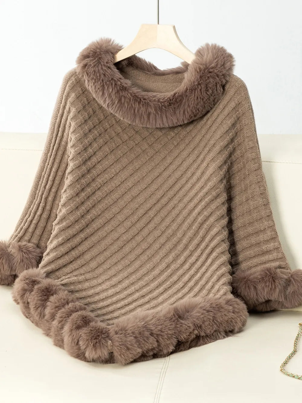 Brown poncho with fur trim on a white background