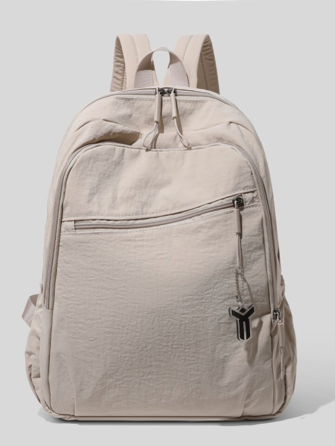 Beige backpack with a visible brand logo on a light gray background