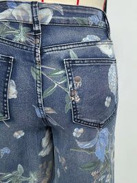 Floral-patterned jeans with a focus on the pocket area.