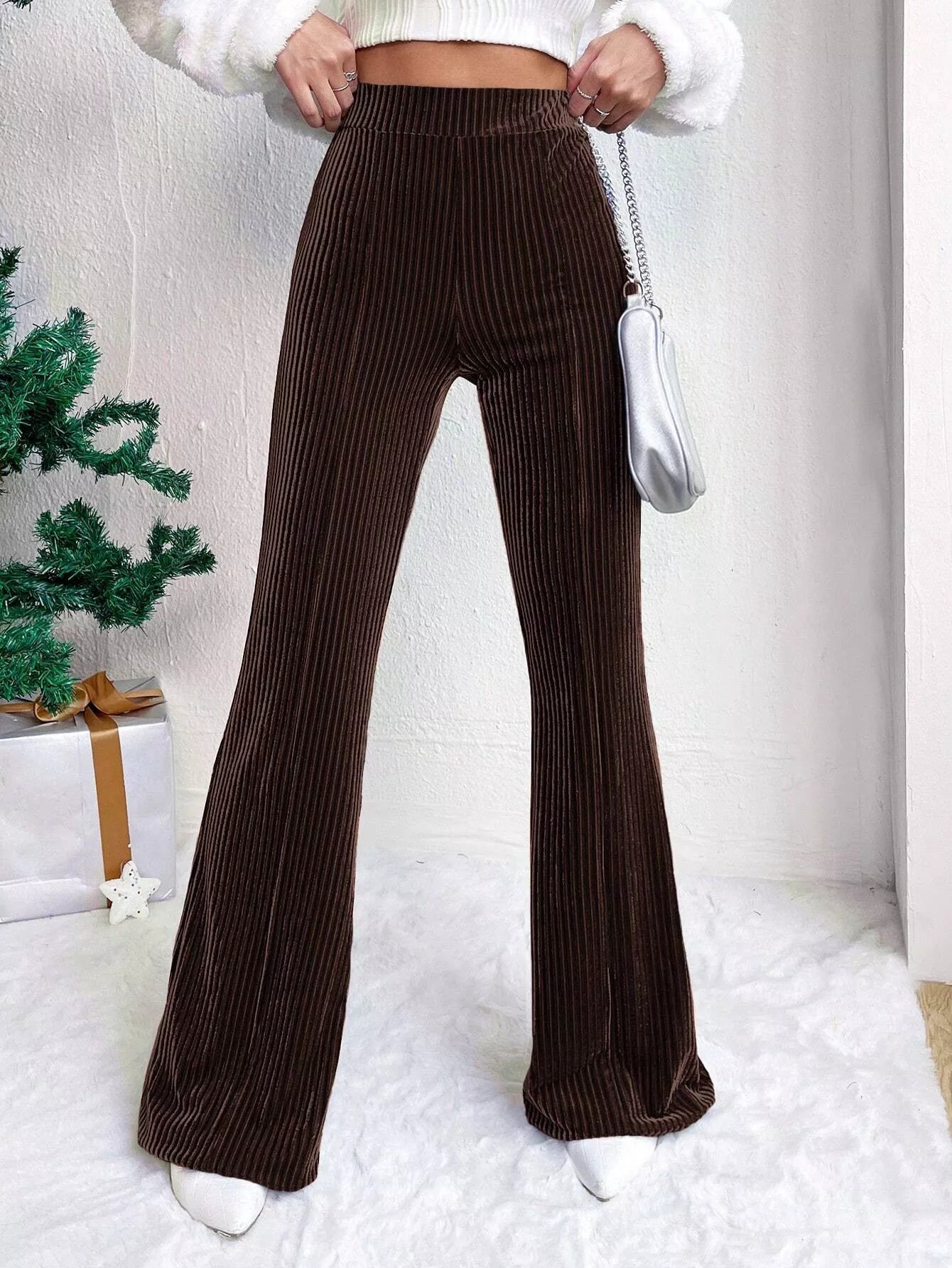 Brown ribbed wide-leg pants worn by a person with a white background