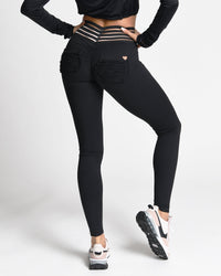 Person wearing black leggings with a white background