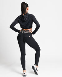 Person wearing a black athletic outfit on a white background