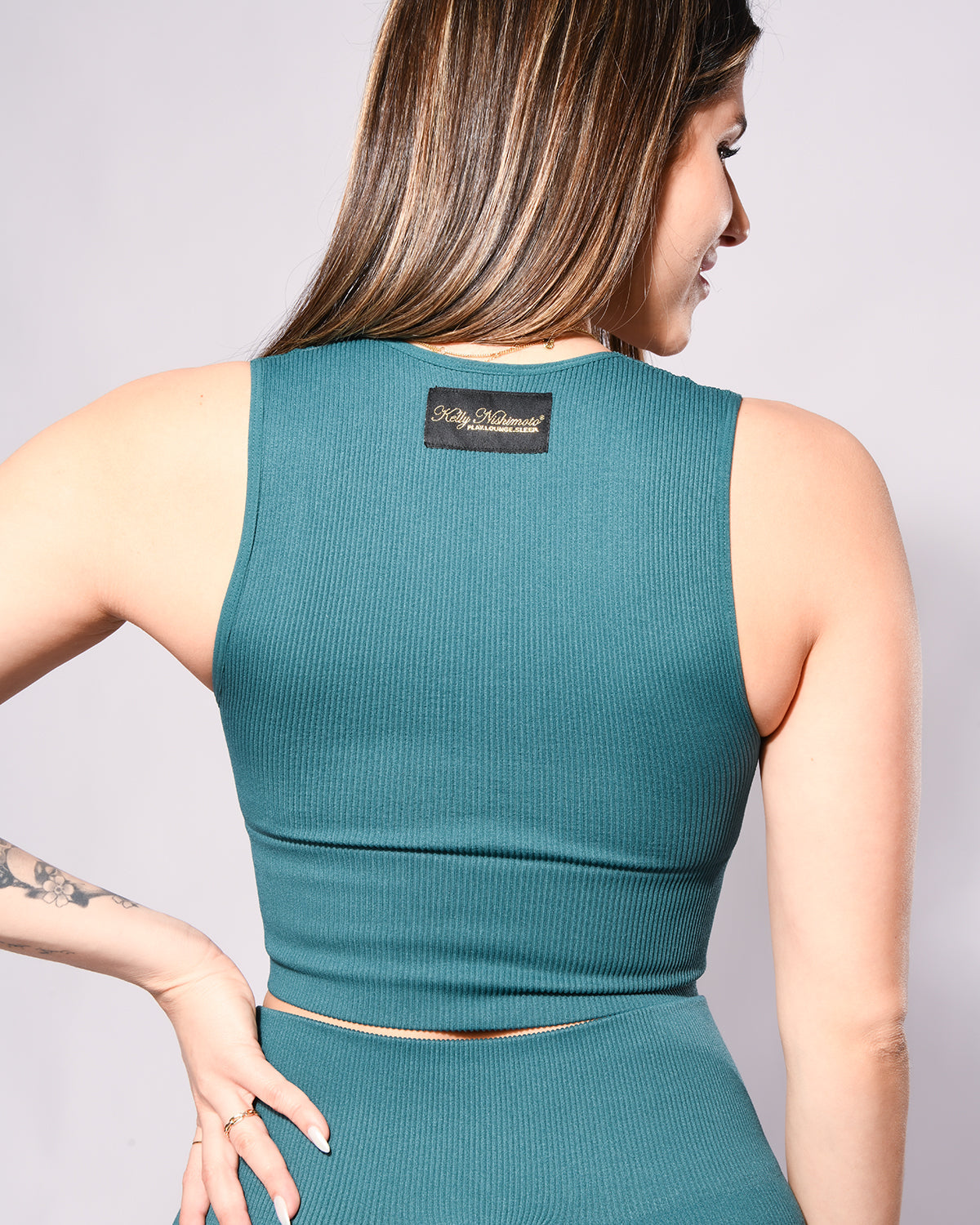 View of the back of *Breezy* (Crop Ribbed Tank)