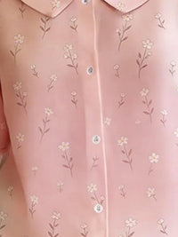 Close-up of a pink shirt with floral pattern