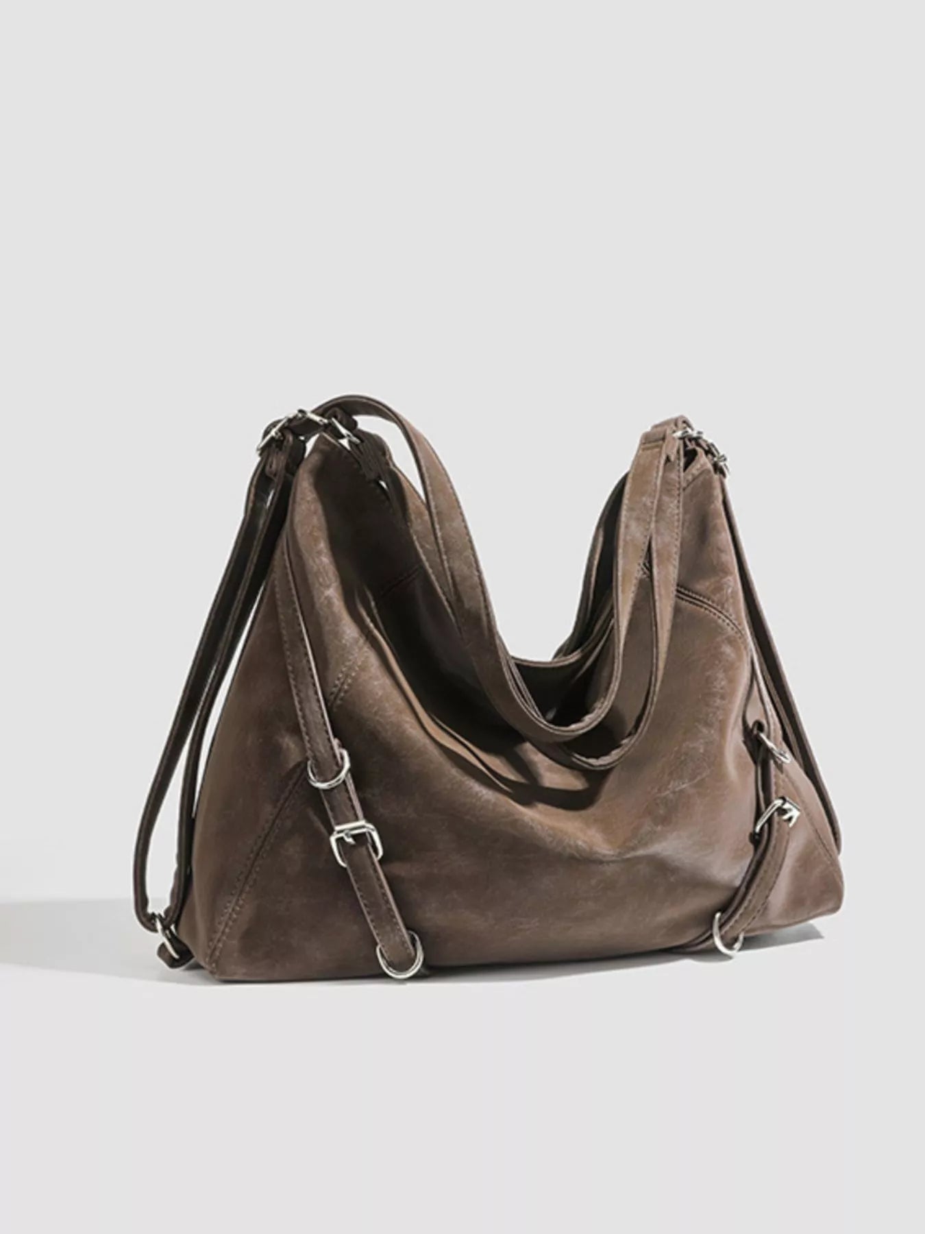 Brown leather handbag on a light gray background