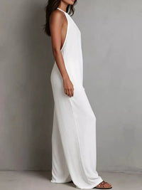 Woman wearing a white sleeveless dress against a gray background