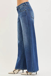 Blue jeans worn by a person on a white background
