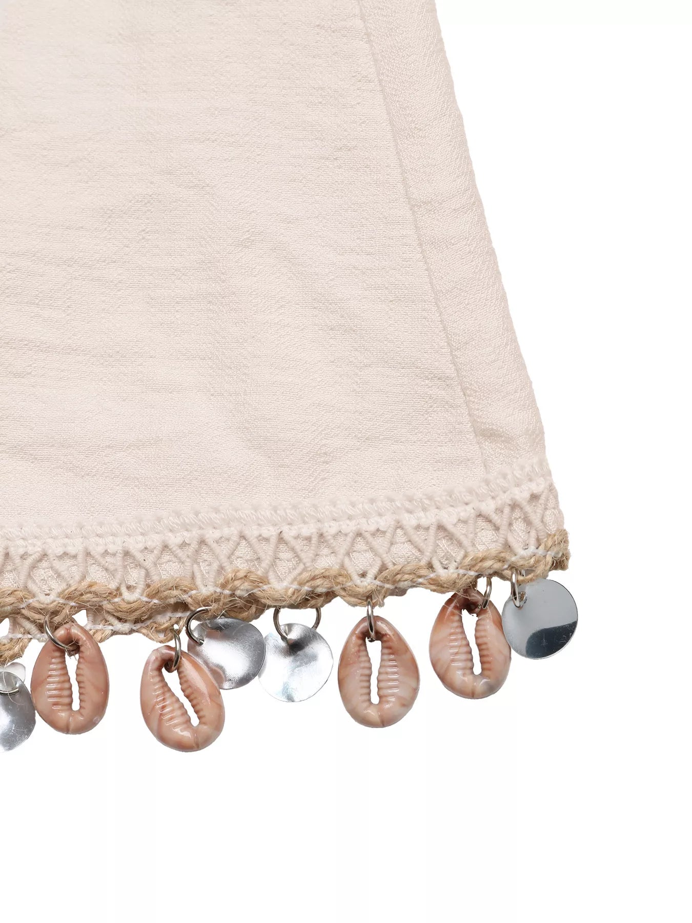 Close-up of a beige fabric with shell and bead embellishments on a white background