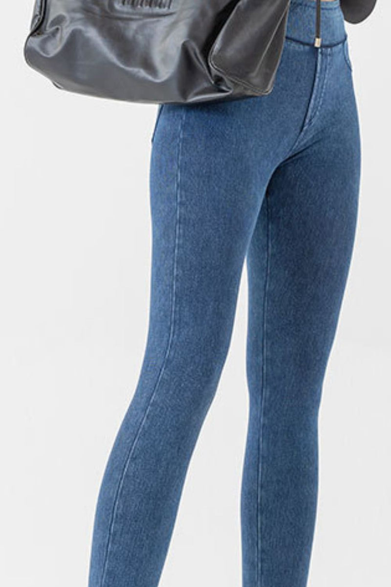 Blue jeans worn by a person on a white background
