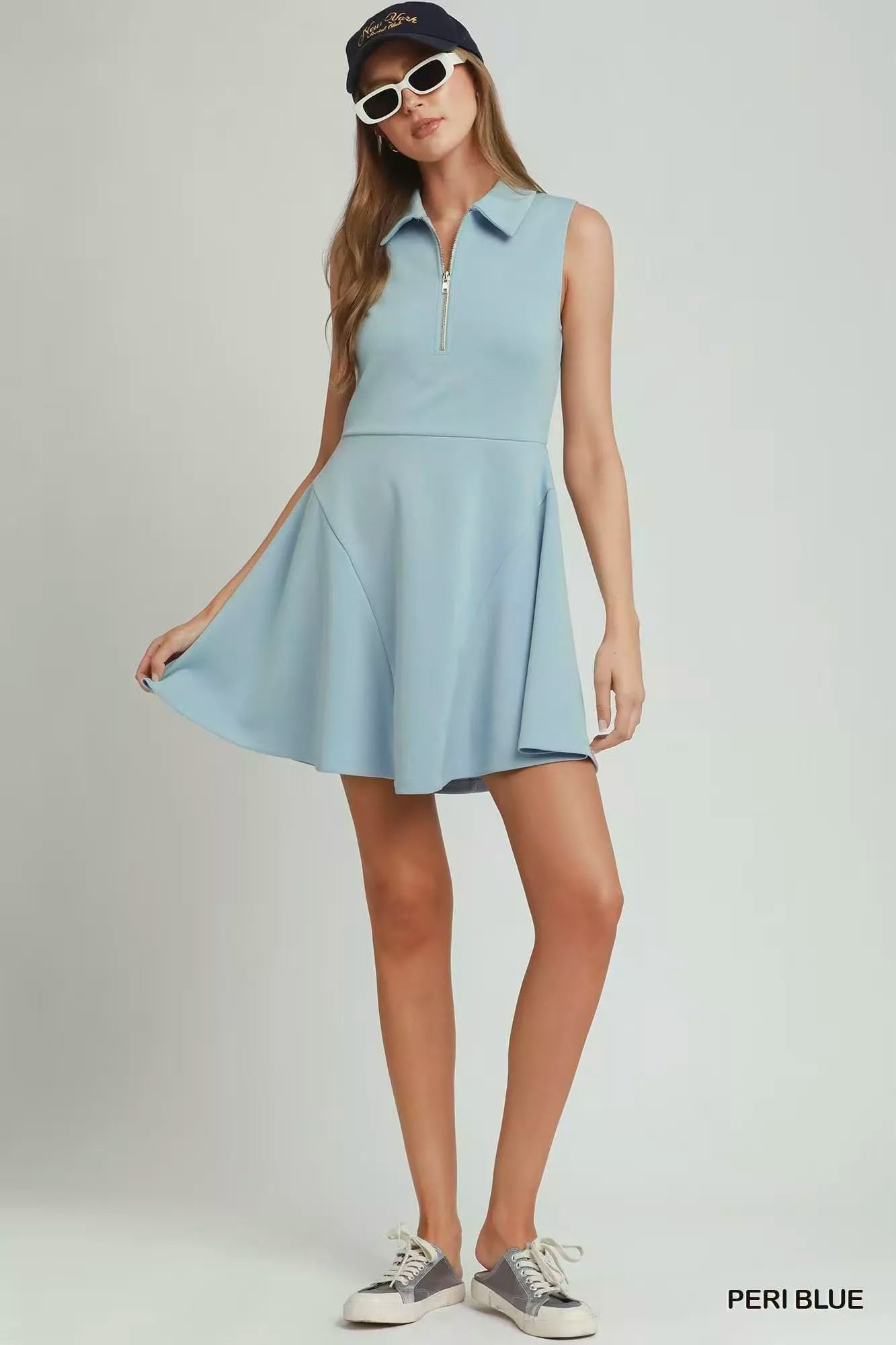 Woman wearing a light blue dress with a white background