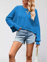 Person wearing a blue sweatshirt and denim shorts on a plain background