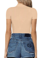 Person wearing a beige top and blue denim shorts on a white background