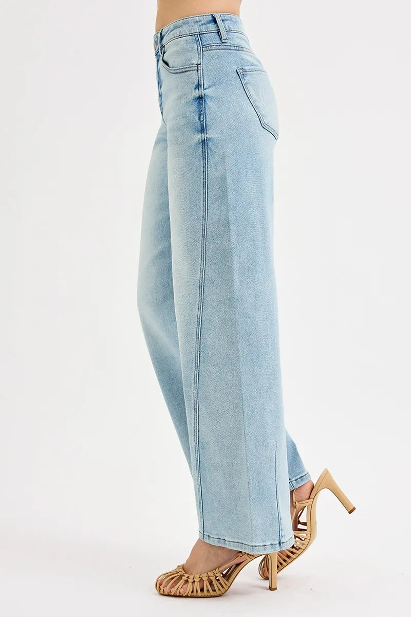 Light blue jeans worn by a person on a white background