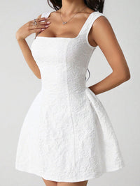 White lace dress on a plain background