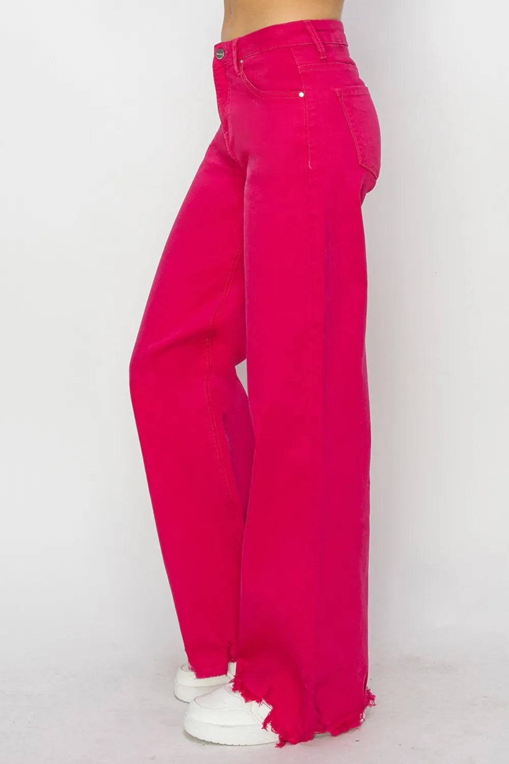 Bright pink jeans on a white background