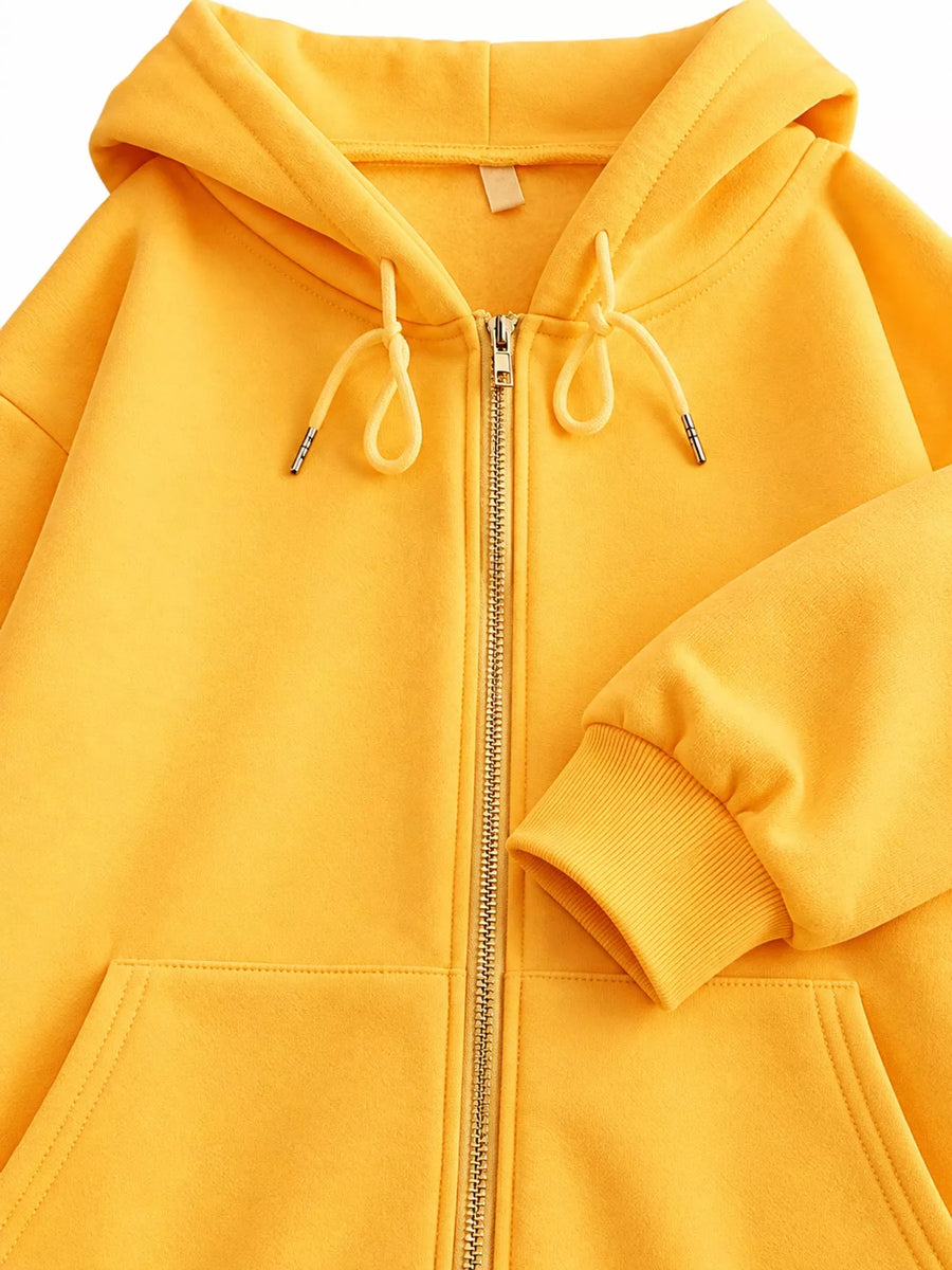 A close-up of a bright yellow zip-up hoodie with a front zipper, drawstrings, and ribbed cuffs, shown against a plain white background.