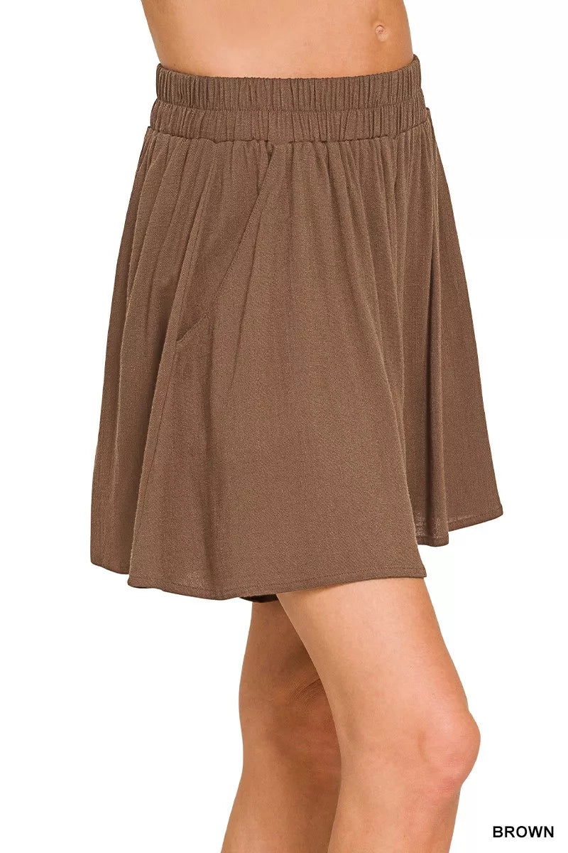 Brown skirt worn by a person on a white background