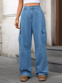 Person wearing blue cargo pants standing on a sidewalk.