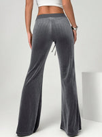 Gray flared pants worn by a person on a white background