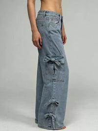 Blue denim cargo pants on a plain background