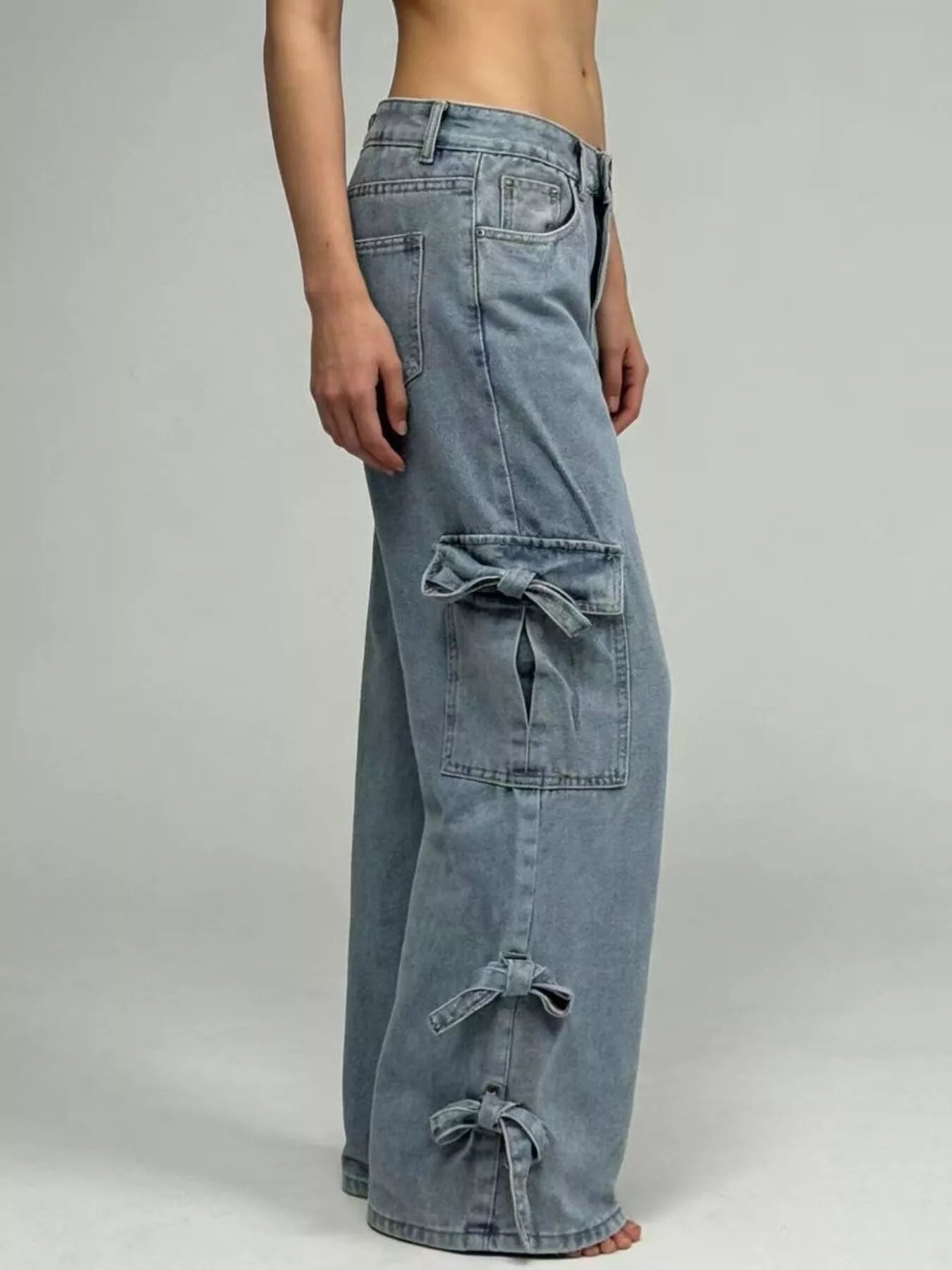 Blue denim cargo pants on a plain background