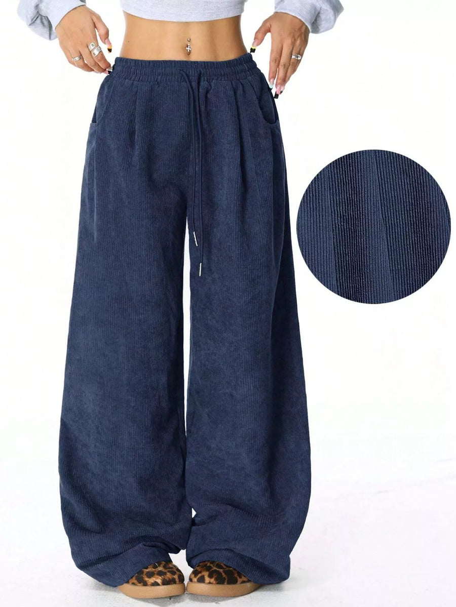 Blue wide-leg pants with a close-up of the fabric texture on a white background
