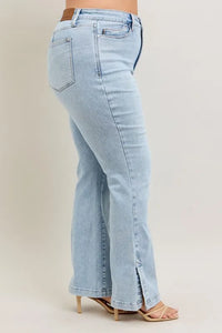 Light blue jeans worn by a person on a beige background