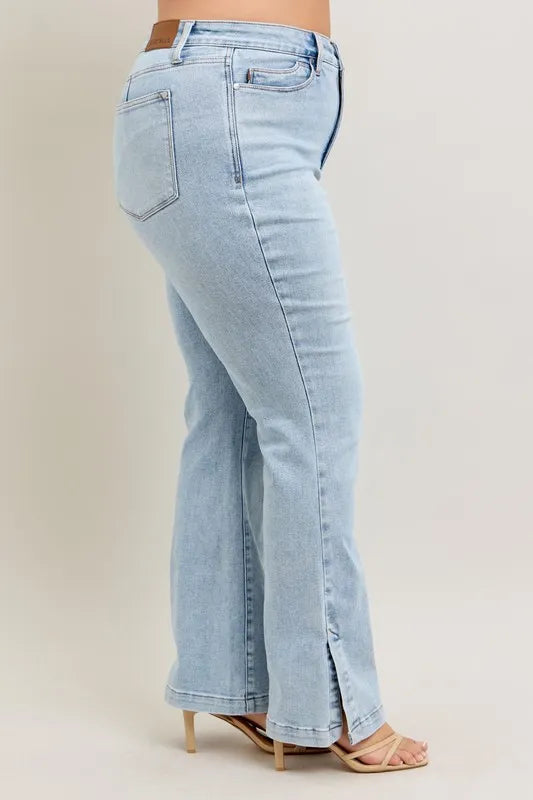 Light blue jeans worn by a person on a beige background