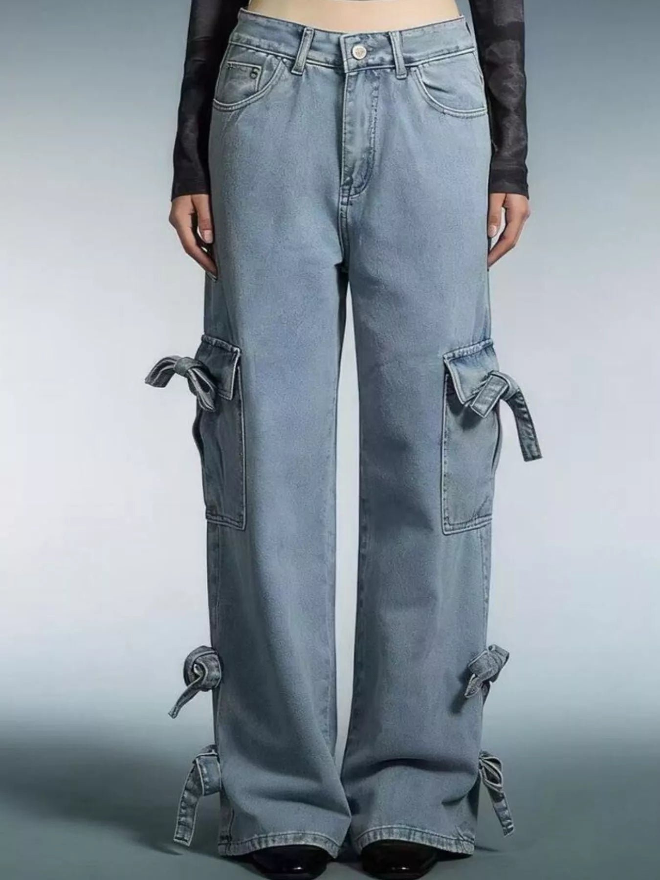 Blue jeans with tie details on a gray background