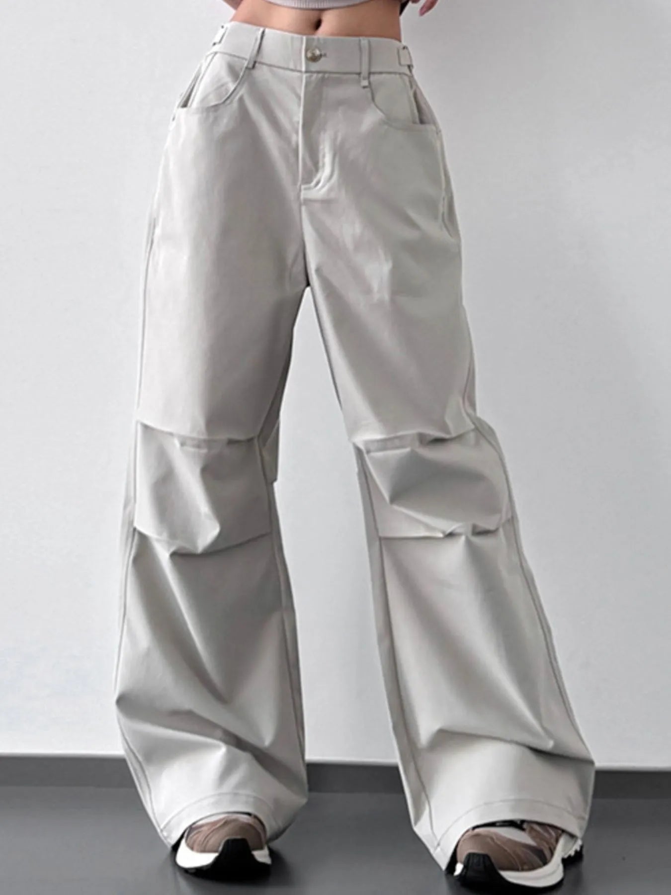 Light gray wide-leg pants on a plain background
