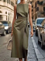 Woman in a green dress walking on a city street.