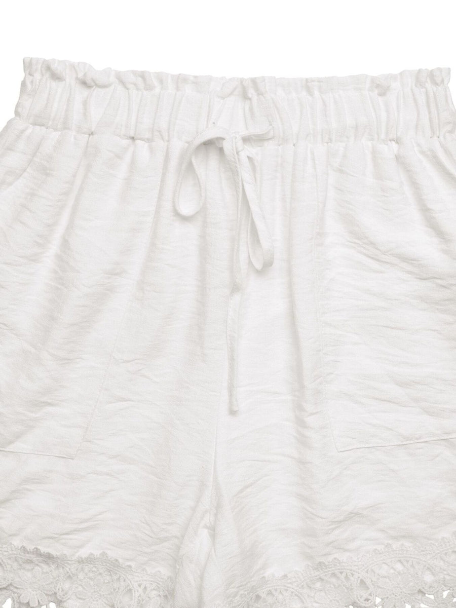 White textured pants with drawstring on a white background