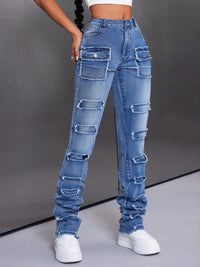 Ripped blue jeans worn by a person on a gray background