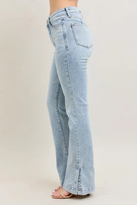 Light blue jeans worn by a person on a plain background