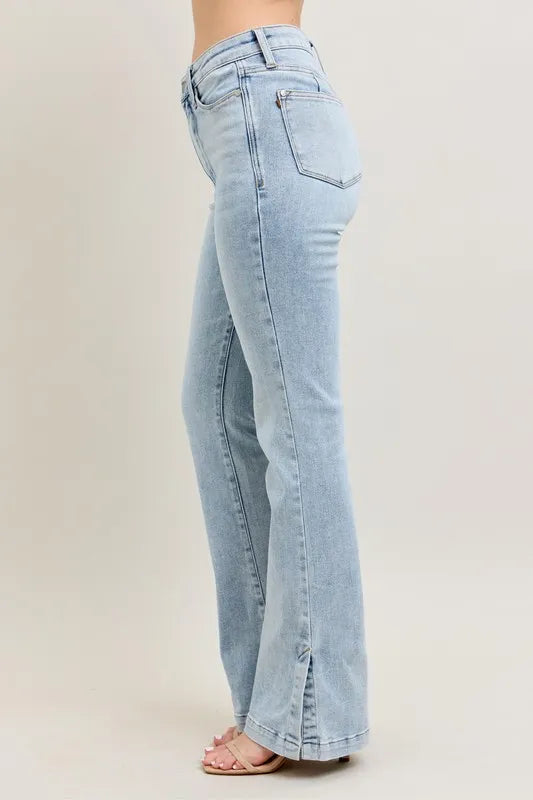 Light blue jeans worn by a person on a plain background