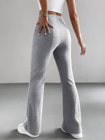 Person wearing gray ribbed pants on a plain background