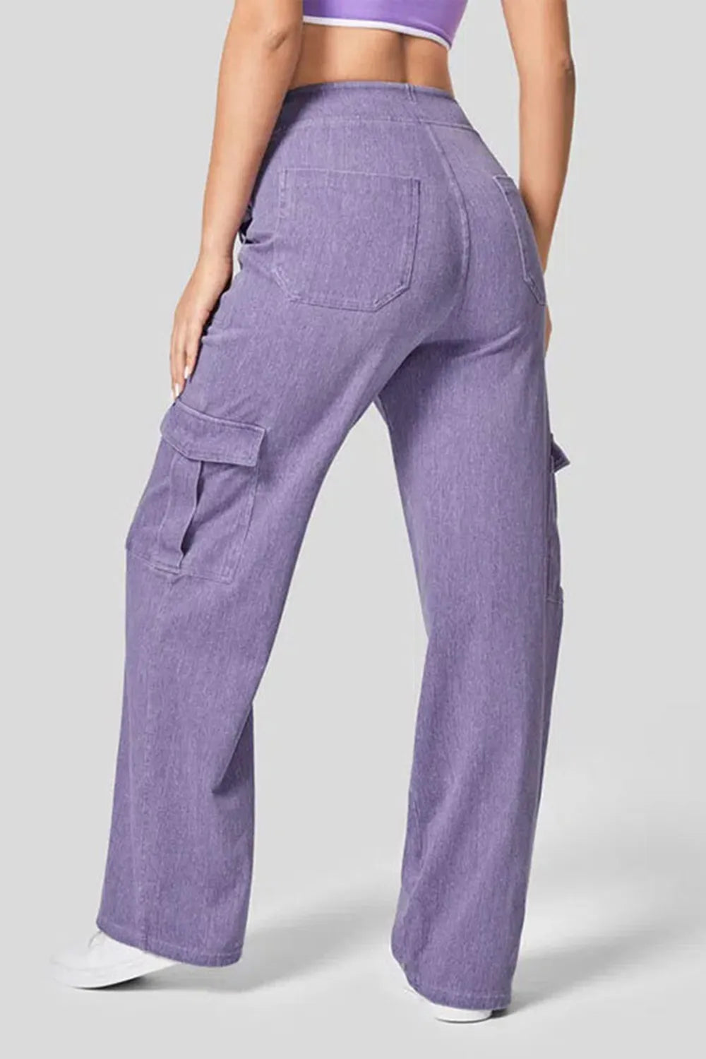 Purple cargo pants worn by a person on a light gray background