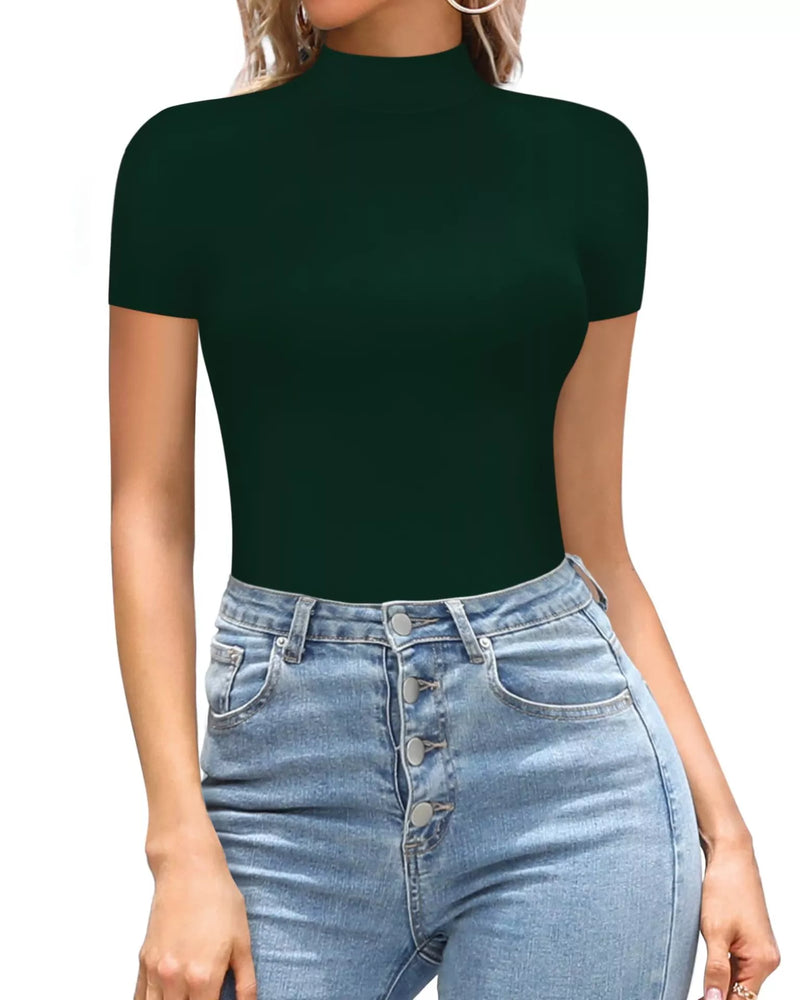 Person wearing a dark green short-sleeve top and light blue jeans on a white background